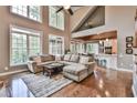 Bright living room with hardwood floors, high ceilings, and large windows overlooking the lush backyard at 5675 Habersham Vly, Suwanee, GA 30024
