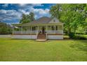 Charming one-story home with a welcoming porch and large front lawn at 123 Nelson Street, Newborn, GA 30056