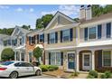 Inviting townhouse showcases classic architecture with neat landscaping, enhancing its curb appeal in a suburban setting at 216 Buckland Dr, Alpharetta, GA 30022