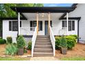 Inviting front porch with wooden posts, white railings, and a charming entrance at 3142 Chamblee Gap Rd, Cumming, GA 30040
