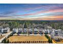 This aerial view displays the neighborhood with a large lawn and beautiful trees at 5293 Hearthstone St, Stone Mountain, GA 30083