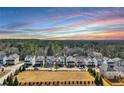 Wide aerial shot showcasing a neighborhood's well-manicured lawns, tree lines, and sky at 5293 Hearthstone St, Stone Mountain, GA 30083