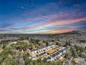 An aerial view showcases the neighborhood with colorful skies and Stone Mountain in the distance at 5293 Hearthstone St, Stone Mountain, GA 30083