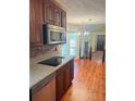 Modern kitchen with stainless steel appliances, granite countertops, and open view to the living room at 626 Cheatham Sw Dr, Marietta, GA 30064