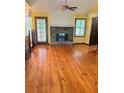 Inviting living room featuring hardwood floors, a stone fireplace, and natural light at 626 Cheatham Sw Dr, Marietta, GA 30064