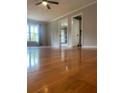 Bright living room featuring hardwood floors, neutral paint, and ample natural light through a large window at 710 Wind Song Trce, Woodstock, GA 30189