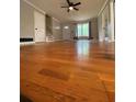 Spacious living room featuring glossy wood floors with stairway and entry view at 710 Wind Song Trce, Woodstock, GA 30189