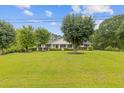 Beautifully maintained home with a spacious green lawn and mature trees providing shade and curb appeal at 256 Teresa Ln, Loganville, GA 30052