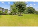 Inviting home with a lush front yard, showcasing mature trees and landscaping at 256 Teresa Ln, Loganville, GA 30052