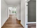 Bright hallway with wood floors leads into the open and airy living space at 8 Foothills Trl, Sharpsburg, GA 30277