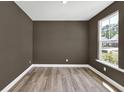 Neutral-toned office space featuring a large window and laminate flooring at 8 Foothills Trl, Sharpsburg, GA 30277