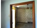 Open doorway showcasing vintage wallpaper and light fixture in the hallway at 1305 Lenox Cir, Atlanta, GA 30306