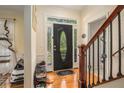 Welcoming foyer boasts hardwood floors, decorative front door, and staircase with wrought iron details at 1644 Beaver Creek Ln, Snellville, GA 30078