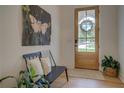 Bright entryway with a decorative wreath, modern furniture, and hardwood floors at 270 Alcovy Reserve Way, Covington, GA 30014