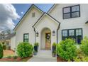 Inviting front porch features a beautifully decorated entrance and manicured bushes at 270 Alcovy Reserve Way, Covington, GA 30014