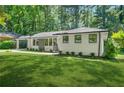 Charming painted brick ranch-style home featuring a well-manicured lawn and mature trees at 3337 Toney Dr, Decatur, GA 30032