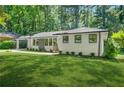 Beautiful brick home with a well-maintained lawn, carport, and stylish, modern windows at 3337 Toney Dr, Decatur, GA 30032