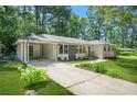 Inviting brick home featuring a carport, updated windows, and a lush green lawn at 3337 Toney Dr, Decatur, GA 30032