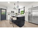 Eat-in kitchen featuring white cabinets, a tile backsplash, an island with seating, and stainless appliances at 3337 Toney Dr, Decatur, GA 30032