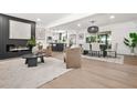 Bright open-concept living space with modern fireplace and decor that flows into the dining and kitchen areas at 3337 Toney Dr, Decatur, GA 30032