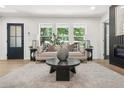 Cozy living area with large windows, a plush sofa, and a chic coffee table at 3337 Toney Dr, Decatur, GA 30032