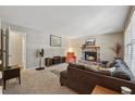 Cozy living room with a stone fireplace, neutral paint, and comfortable furniture at 461 Village Green Sw Ct, Lilburn, GA 30047