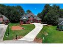Attractive brick home with long driveway and manicured landscaping on a sunny, green lot at 781 Templeton Dr, Loganville, GA 30052