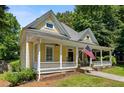 Charming yellow two-story home with an inviting front porch, mature trees, and well-manicured lawn at 161 N Barton St, Norcross, GA 30071