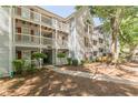 Apartment complex with multiple balconies, red shutters, and manicured landscaping at 215 Cobblestone Trl, Avondale Estates, GA 30002