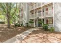 Condo exterior with balconies, red shutters, and a sidewalk leading to the entrance at 215 Cobblestone Trl, Avondale Estates, GA 30002
