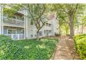 Exterior view of the apartment with a walkway and manicured landscaping at 215 Cobblestone Trl, Avondale Estates, GA 30002
