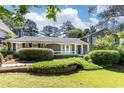 Lovely home with a well-kept lawn, a stone accent wall, and lush landscaping, offering great curb appeal at 3099 Farmington Se Dr, Atlanta, GA 30339