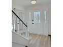 Bright foyer with stylish front door and staircase, showcasing modern flooring and fresh paint at 4756 Manly Ct, Stone Mountain, GA 30088
