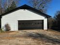 A large, two-car garage with a dark gray door, offering ample parking and storage space at 4756 Manly Ct, Stone Mountain, GA 30088