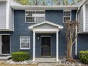 Close-up of townhome entrance featuring a black door, white trim, and stone landscaping at 3149 Buford Hwy # 3, Brookhaven, GA 30329