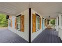 Charming covered front porch with rocking chairs and a stylish blue door at 377 Wyndham Way, Atlanta, GA 30315