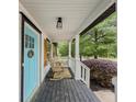 Cozy front porch with rocking chairs, white columns, and a dark-stained wooden floor at 377 Wyndham Way, Atlanta, GA 30315