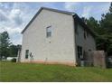 Rear exterior of the two-story home showing the brick facade and yard at 12351 Styron Dr, Hampton, GA 30228