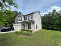 Charming two-story home with a well-manicured lawn and an attached two-car garage at 12351 Styron Dr, Hampton, GA 30228