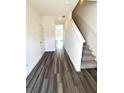 Inviting entryway with hardwood flooring and a staircase leading to the upper level at 311 Winton Way, Villa Rica, GA 30180