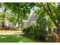 Landscaped yard surrounding a gray home with white trim at 1367 Ormewood Se Ave, Atlanta, GA 30316