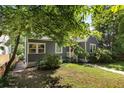 Gray home with white trim, front lawn and mature trees at 1367 Ormewood Se Ave, Atlanta, GA 30316