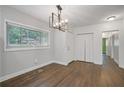 The dining room showcases hardwood floors, a modern chandelier, and an abundance of natural light at 2049 Rector Sw Dr, Atlanta, GA 30311