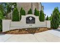 An inviting entrance to The Townes at Chastain community with professional landscaping at 4355 Parkside Pl, Sandy Springs, GA 30342
