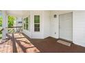 A cozy covered porch with wooden floors, offering a perfect spot for relaxation at 628 Warren Ave, Scottdale, GA 30079