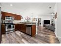 Stylish kitchen and partial view of the living room with stainless steel appliances and wood finish cabinets at 870 Mayson Turner Rd Nw # 1111, Atlanta, GA 30314