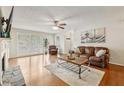 Bright living room featuring hardwood floors, fireplace, ceiling fan, and ample natural light at 2304 Country Park Se Dr, Smyrna, GA 30080