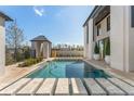 Inviting pool with stone accents and lush greenery, offering a serene backyard escape at 245 Roycroft Ln, Fayetteville, GA 30214