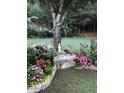Beautifully landscaped garden featuring a variety of colorful flowers and lush greenery, creating a serene outdoor space at 3554 Umatilla Sw Ln, South Fulton, GA 30331