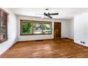 Well-lit living room boasts gleaming hardwood floors and a large window for ample natural light and a ceiling fan at 511 Oakview Rd, Decatur, GA 30030